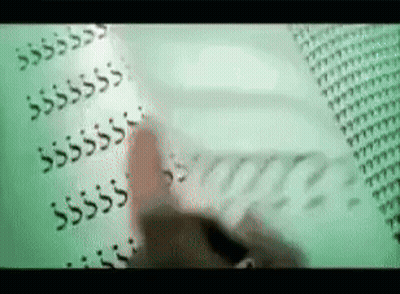 A Person Is Writing On A Piece Of Paper With A Pen GIF