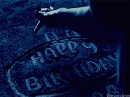 A Person Is Writing The Word Happy Birthday On A Concrete Surface GIF