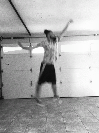 A Person Jumping In The Air In A Garage GIF