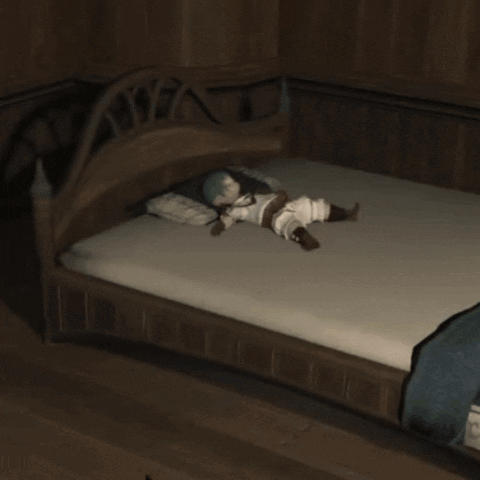 A Person Kneeling In Front Of A Bed With A Blue Blanket On It GIF