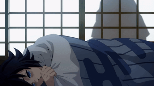 A Person Laying On A Bed With A Blue Blanket That Says H GIF