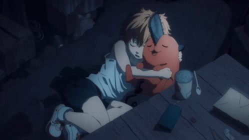 A Person Laying On A Bed With A Stuffed Animal In Their Arms GIF