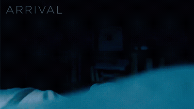 A Person Laying On A Bed With The Word Arrival Behind Them GIF