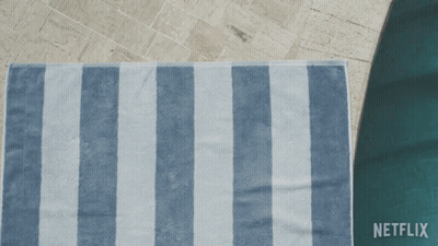 A Person Laying On A Blue And White Striped Towel With Netflix Written On The Bottom GIF