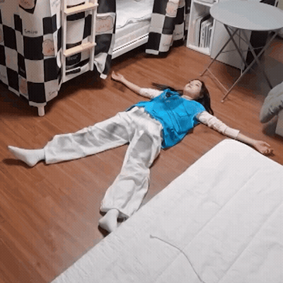 A Person Laying On The Floor With The Word Smile On The Wall GIF
