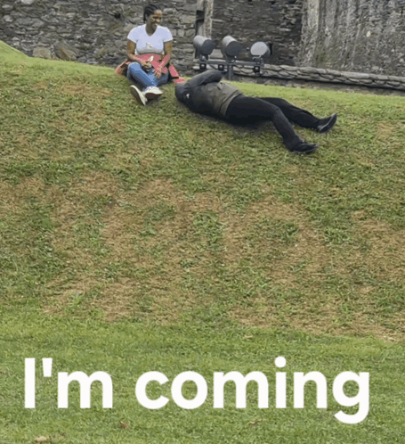 A Person Laying On The Grass With The Words I 'M Coming Written Below Them GIF