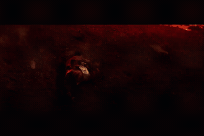 A Person Laying On The Ground In A Dark Room GIF