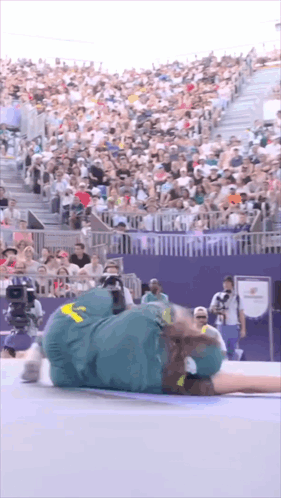 A Person Laying On The Ground With A Yellow Sticker On Their Pants GIF