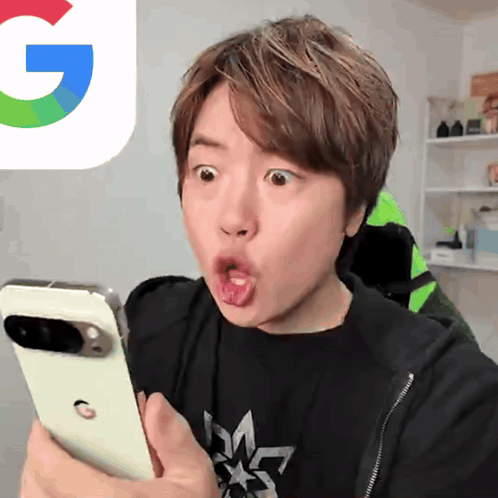 A Person Looking At A Cell Phone With A Google Logo Behind Them GIF