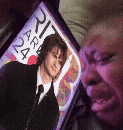 A Person Looking At A Picture Of A Man With The Number 24 On The Screen GIF