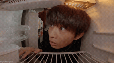 A Person Looking Into A Refrigerator With The Website Dryedmangoes.com Visible GIF