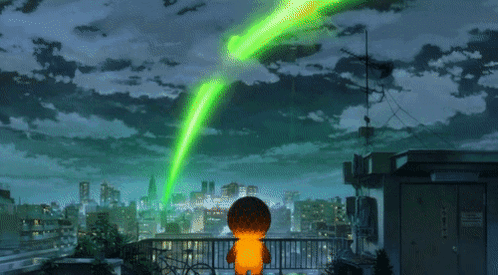 A Person On A Balcony With A Green Light Coming From The Sky GIF