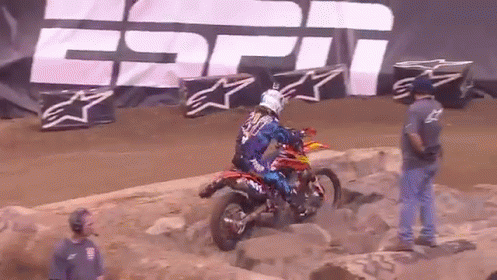 A Person On A Dirt Bike In Front Of A Espn Sign GIF