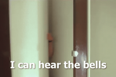 A Person Peeking Out From Behind A Door With The Words I Can Hear The Bells Below Them GIF