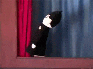 A Person Peeking Out From Behind A Red Curtain With A Blue Curtain Behind Them GIF