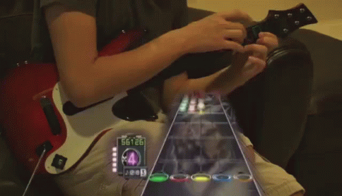 A Person Playing A Guitar With A Screen Showing The Number 88926 GIF