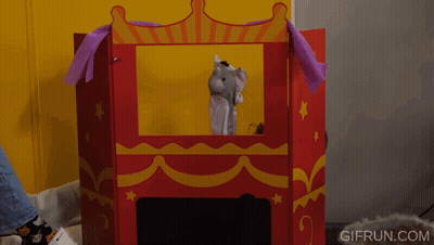 A Person Playing With A Puppet In A Puppet Theater With Gifrun.com Written On The Bottom Right GIF