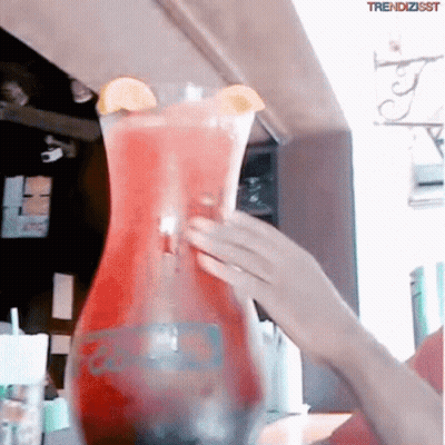 A Person Pouring A Drink Into A Pitcher That Says Trendzisst On The Bottom GIF