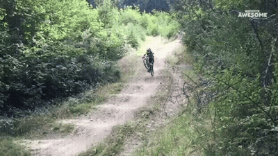 A Person Riding A Bike Down A Dirt Road With The Words Awesome Written On The Bottom GIF