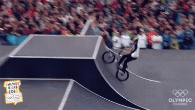 A Person Riding A Bike On A Ramp With The Olympic Channel Written On The Bottom GIF