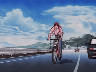 A Person Riding A Bike On A Road With A Car Behind Them GIF