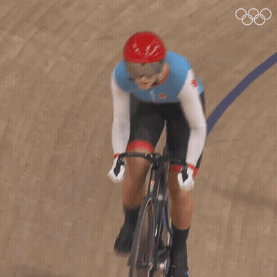 A Person Riding A Bike On A Track With The Number 1 On Their Shirt GIF