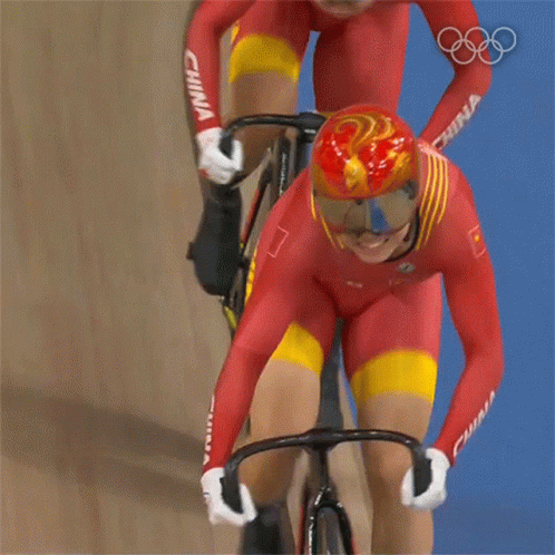 A Person Riding A Bike With A Helmet That Has A Bird On It GIF