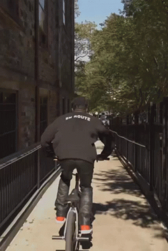 A Person Riding A Bike With The Word Route On The Back Of Their Shirt GIF
