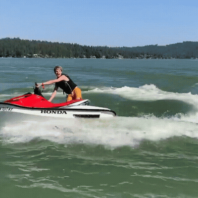 A Person Riding A Honda Jet Ski In The Water GIF