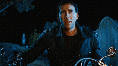A Person Riding A Motorcycle In Front Of A Large Fire GIF