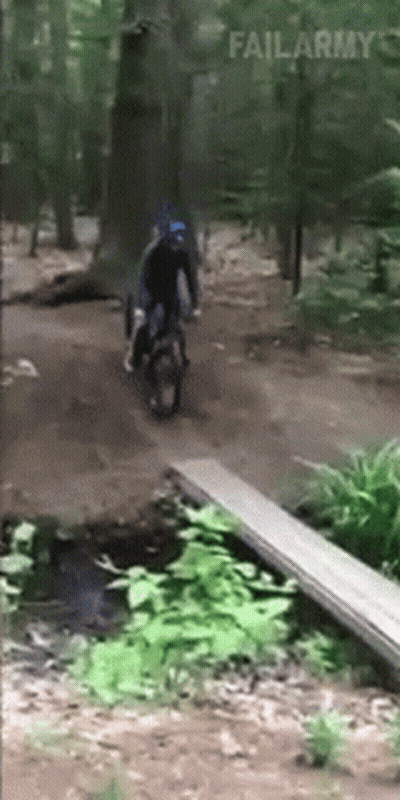 A Person Riding A Motorcycle In The Woods With Failarmy Written In The Corner GIF