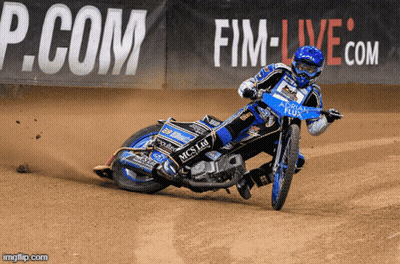 A Person Riding A Motorcycle On A Dirt Track With A P.com Sign In The Background GIF