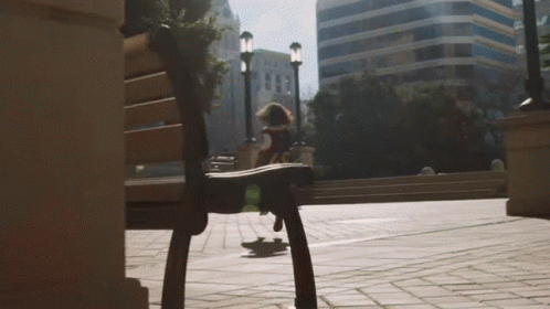 A Person Riding A Skateboard In Front Of A Building That Says ' A & T ' On It GIF