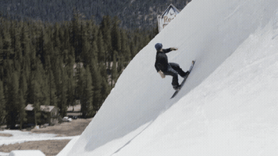 A Person Riding A Snowboard Down A Snowy Slope With A Red Bull Sign In The Background GIF