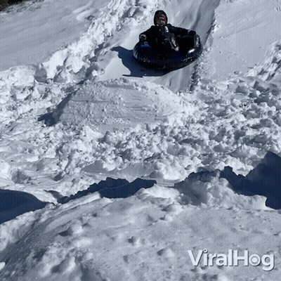 A Person Riding A Tube Down A Snowy Hill With The Words Viralhog On The Bottom Of The Image GIF