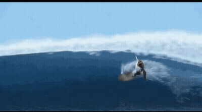 A Person Riding A Wave In The Ocean GIF