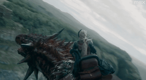 A Person Riding On The Back Of A Dragon With The Word Max On The Bottom GIF