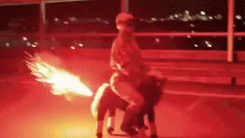 A Person Riding On The Back Of A Horse With A Fire Coming Out Of Its Tail GIF