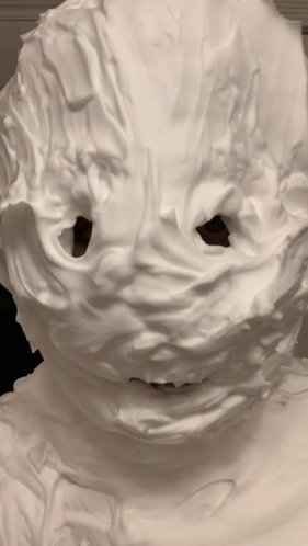 A Person 'S Face Is Covered In Whipped Cream And Has A Hole In It GIF