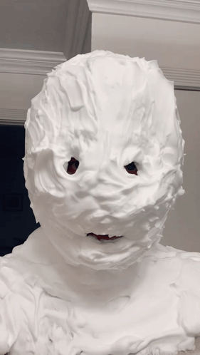 A Person 'S Face Is Covered In Whipped Cream And Looks Like A Snowman GIF