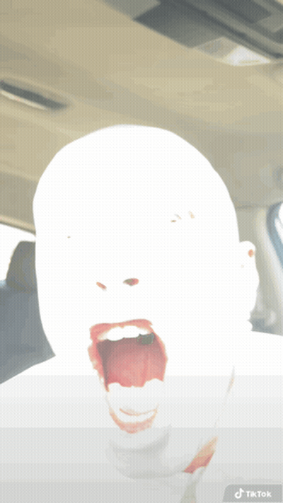 A Person 'S Face Is Visible In A Car With A Tiktok Sticker On The Bottom GIF
