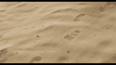 A Person 'S Feet Are Covered In Sand While Walking On A Sandy Beach . GIF