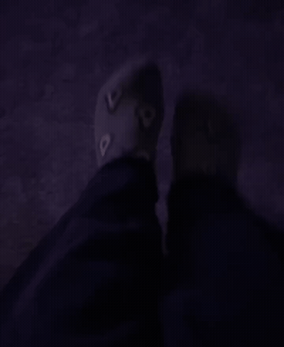 A Person 'S Feet Are Shown In A Dark Room With A Purple Carpet GIF