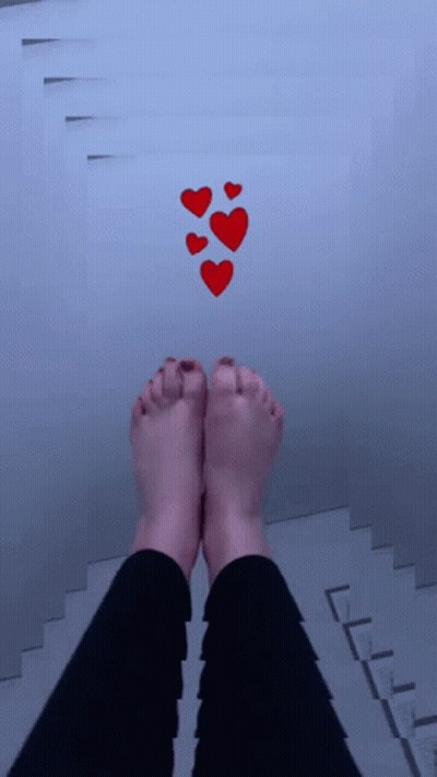 A Person 'S Feet Are Standing On A Staircase With Red Hearts Floating Above Them GIF