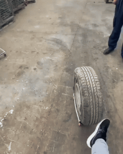 A Person 'S Foot Is On A Tire That Has A Black Stripe On It GIF