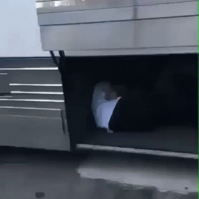 A Person 'S Foot Is Sticking Out Of The Trunk Of A Silver Vehicle GIF