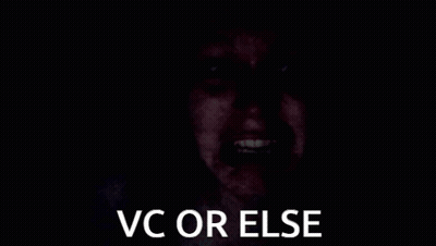 A Person 'S Hand Is Covering Their Face In The Dark With The Words `` Vc Or Else '' . GIF