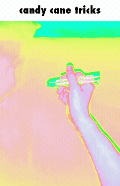 A Person 'S Hand Is Holding A Candy Cane With The Words Candy Cane Tricks Above It GIF