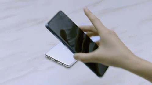 A Person 'S Hand Is Holding A Cell Phone With A Samsung Logo On The Side GIF
