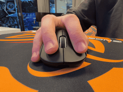 A Person 'S Hand Is Holding A Computer Mouse On An Orange And Black Mouse Pad GIF